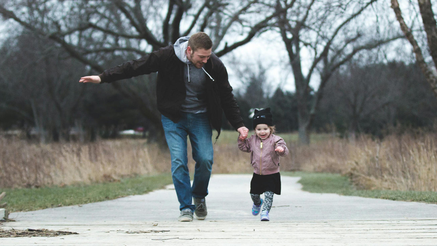 Dad is teaching his daughter to walk
