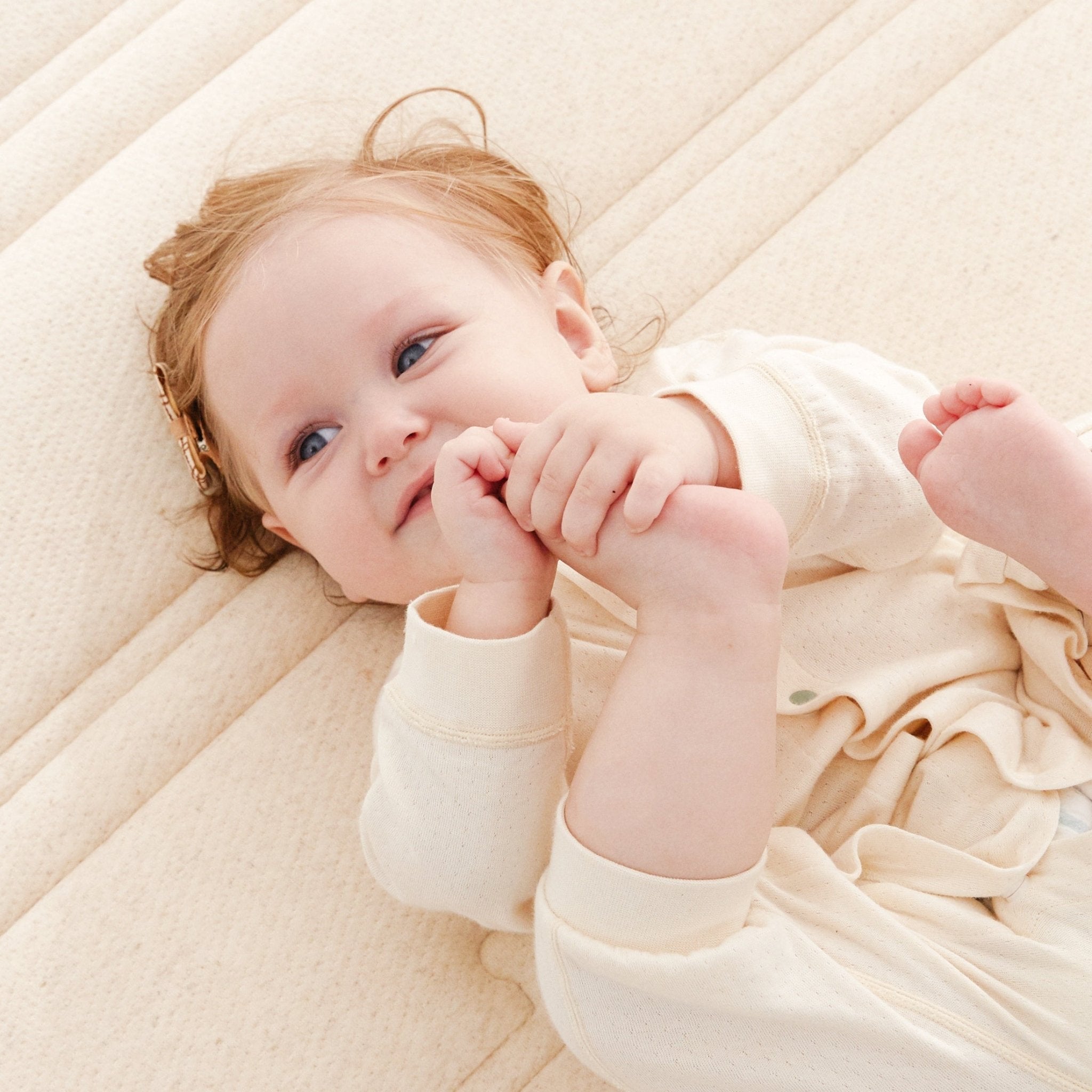 Baby lying on KUB crib mattress